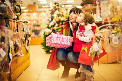 A woman and child browsing gifts in a store, captivated by the array of options available.